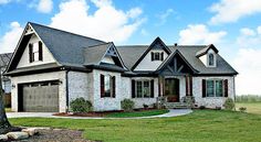 a large house with two garages in the front yard