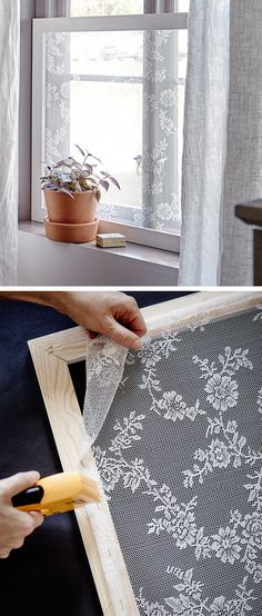 a person is cutting fabric with a pair of scissors on the window sill next to a potted plant