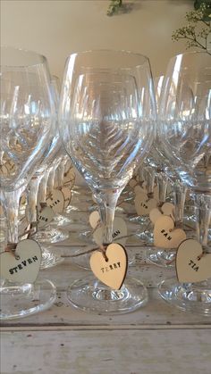 several wine glasses with wooden hearts on them