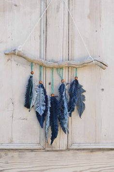 three feathers hanging from a rope on a door