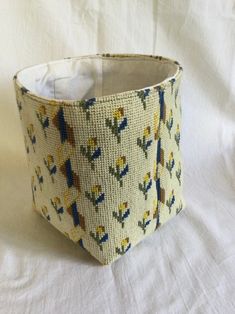 a close up of a cloth basket on a white surface with an animal pattern in the middle