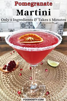 the pomegranate martini is served in a coupe glass with an orange slice on top