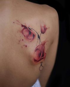 a woman's stomach with red flowers on it