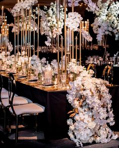 a long table with white flowers and candles