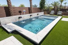 a pool with artificial grass and palm trees