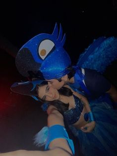 two people dressed in costumes posing for a photo