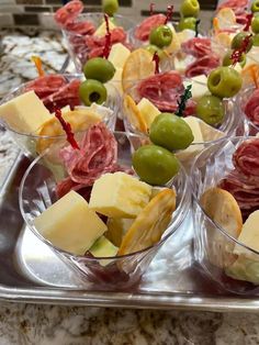 several small cups filled with different types of food on a tray next to a marble counter top