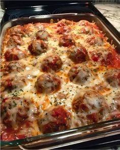 a casserole dish filled with meatballs and cheese