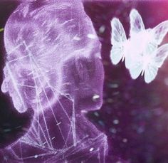 two white butterflies flying over a woman's face in purple and pink light with blurry background