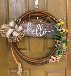 a wreath that says hello hanging on a door