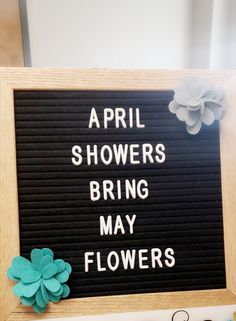 a sign with flowers on it that says, april showers bring may flowers in black and white