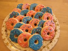 there are many doughnuts on the plate with sprinkles all over them