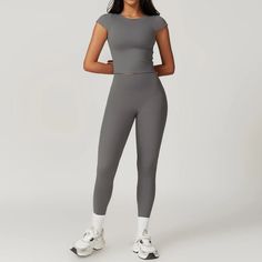 Unleash your inner slayer with the Hermera T-Leggings Set. Whether you're hitting the gym or relaxing at home, these high-waisted leggings offer both support and comfort. The full-length top has a high neckline and a shelf bra with removable padding, providing a tailored fit. Elevate your workout wardrobe with this stylish set! Product Details: Nylon/Spandex 2 Piece Set High-waist legging Top with cap sleeves, waiste length Built in shelf bra with removable padding Imported Sporty Snug Fit Leggings For Loungewear, High Stretch Gray Tights For Loungewear, Gray Elastane Activewear For Loungewear, Snug Fit Athleisure Leggings For Gym, Snug Fit Yoga Activewear In Athleisure Style, Gray Tight Fit Activewear For Loungewear, Snug Fit Athleisure Activewear For Yoga, Snug Fit Yoga Athleisure Activewear, Snug Fit Elastane Leggings For Workout