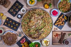 a table topped with plates and bowls filled with different types of food on top of it