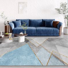 a modern living room with blue velvet couches and geometric rugs on the floor