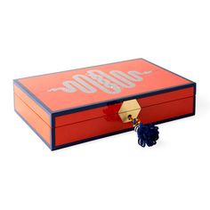 an orange and blue box with a tassel hanging from it's side on a white background