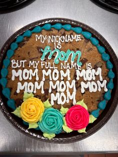 a cake that has been decorated with flowers and writing on the top is sitting on a table