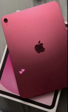 two ipads sitting on top of each other in front of a gray background with pink accents