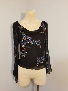 "++ NEWPORT NEWS SILK BLOUSE ++ Gorgeous sequin and beaded top Colorful floral design of sequins Draped neckline See through/sheer bell sleeves Snaps on the interior to hold your bra strap up Fully lined except for the sleeves 100% Silk  Size 12 Made in India In excellent vintage condition -  the interior lining has been sew a bit at the back - no rips or tears I just think it probably stuck out a little but under the silk -  ✂ - - - Measurements laid flat: Pit to pit: 20\" Waist: 17.5\" Hips: 1 Hand Embellished Tops For Wedding, Fitted Silk Blouse Hand Embellished, Fitted Hand Embellished Tops For Wedding, Silk Sequin Top For Wedding, Elegant Long Sleeve Blouse With Sequins, Elegant Long Sleeve Sequined Blouse Piece, Elegant Long Sleeve Sequin Blouse, Festive Embellished Tops For Wedding, Festive Embellished Wedding Tops