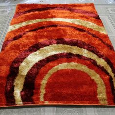 an orange and red rug on the floor