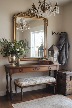 a room with a mirror, bench and flowers on the table in front of it