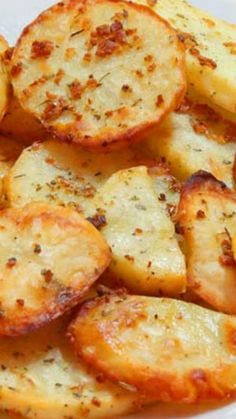 some potatoes are sitting on a plate with seasoning sprinkled on them and ready to be eaten