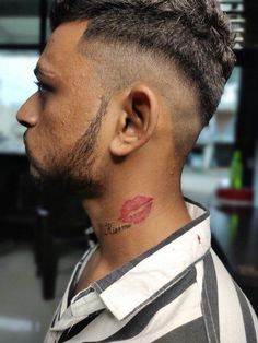 a man with a tattoo on his neck