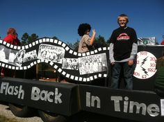 two people standing in the back of a truck with signs on it that read flash back in time