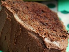 a piece of chocolate cake sitting on top of a green plate