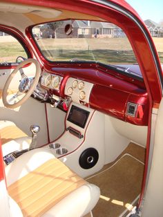 the interior of an old car with wood trim