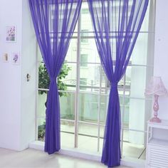 the purple curtains are hanging in front of the window