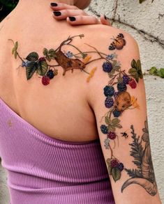 a woman with tattoos on her shoulder and arm