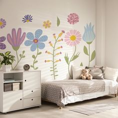 a child's bedroom with flowers painted on the wall