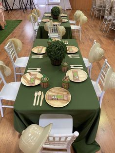 the table is set with plates and place settings for people to sit down at it