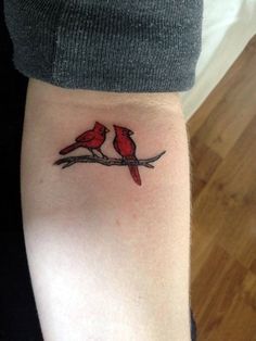 two red birds sitting on a branch tattoo