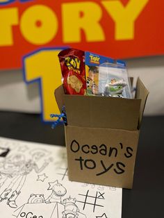 an open box filled with toys sitting on top of a table next to a sign that says ocean's toys