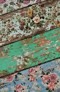 an old wooden wall with flowers painted on it