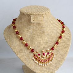 Beautiful fancy pendant with red and white stones studded. For string I have make combination of dholki gold beads and red beads. It gives elegant look. Length is 18 inches. Extra rings are attached. As this is my own design and made by me ,I will make changes according your choice. For any changes please message me. Ruby Necklaces For Diwali Celebration, Festive Red Ruby Kundan Necklace, Ruby Necklace For Diwali Gift, Red Temple Jewelry Necklace For Diwali, Red Kundan Necklace With Round Beads In Temple Style, Red Beaded Kundan Necklace In Temple Style, Red Kundan Temple Necklace For Festivals, Red Ruby Kundan Necklace For Diwali, Temple Jewelry Style Necklace With Beaded Chain For Wedding