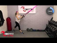 a woman is doing exercises in the gym with a resistance band and an exercise ball