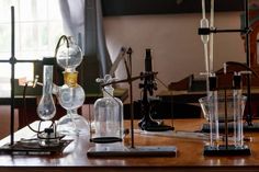 an assortment of laboratory equipment sitting on top of a wooden table