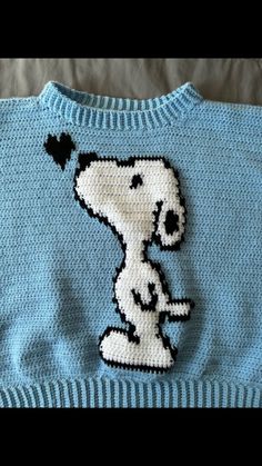 a blue sweater with a snoopy dog on it