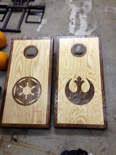 two star wars themed cornhole boards sitting on top of a table next to pumpkins