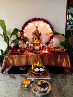 a table topped with lots of food next to a candlelight display on top of a table