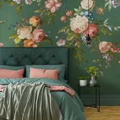 a bed sitting under a green wall with flowers painted on the walls and in between two nightstands