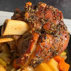 a close up of food on a plate with potatoes, carrots and other foods