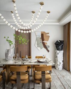 an elegant dining room with marble table and brown leather chairs, white balls hanging from the ceiling