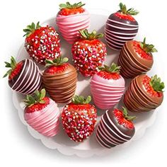 chocolate covered strawberries arranged on a plate with sprinkles and strawberry slices