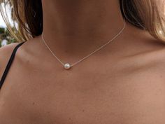 "This lovely single pearl on a delicate sterling silver chain makes a wonderful gift for your bridesmaids or flower girls! They will love it and certainly wear it again! It will provide a simple, elegant touch for them on your special day! This beautiful cultured freshwater pearl and sterling silver necklace is stunning! Simple and gorgeous, the look of this delicate sterling silver chain accented by a single round 7 mm cultured freshwater pearl is both classic and on trend. This choker is a per Floating Pearl Necklace, Dainty Pearl Necklace, Single Pearl Necklace, Bridesmaids Gift Sets, Single Pearl, Pearl Necklace Earrings, Prom Jewelry, Pearl Choker, Simple Jewelry