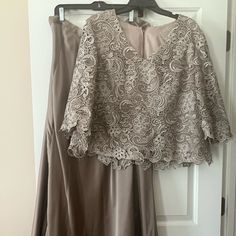 a dress hanging on a hanger in front of a door