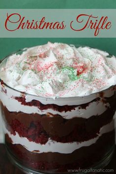 a christmas trifle cake with white frosting and sprinkles on top